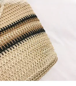 Detailed macro view of natural straw woven fabric with black and brown stripe accents