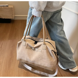 Detail view of beige tote bag showing high-capacity design and thick durable handles