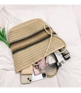 Close-up of woven straw tote bag showing spacious interior with daily essentials