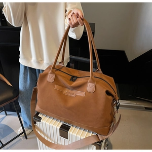 Brown leather travel tote bag with NINGJIA embossing and detachable shoulder strap