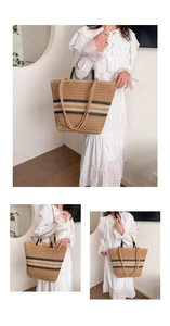 Detail of hand-woven straw tote bag with black and white stripes and sturdy handles