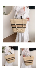 Detail view showing woven straw texture and dual handles of the large tote bag