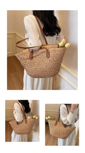 Detail of handwoven beige tote bag featuring deep brown leather straps and spacious interior