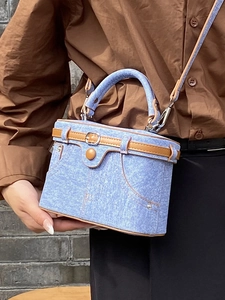 Chic blue denim box handbag with brown leather trim and adjustable crossbody strap