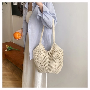 Detail of minimalist cream woven tote bag showing intricate mesh pattern and cotton texture