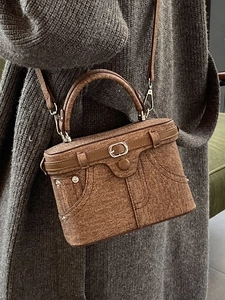 Brown textured denim-style handbag with jeans pocket design and silver hardware details