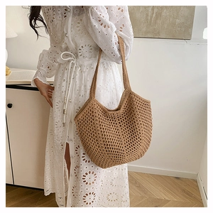 Detail view of khaki crochet tote bag featuring intricate hollow weave and bohemian style