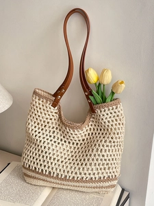 Artistic cream woven tote bag with brown handles and yellow tulips in a lifestyle setting