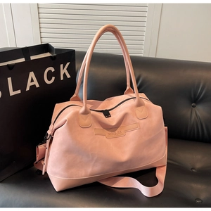 Detail of light pink large capacity tote bag with adjustable strap and NINGJIA logo patch