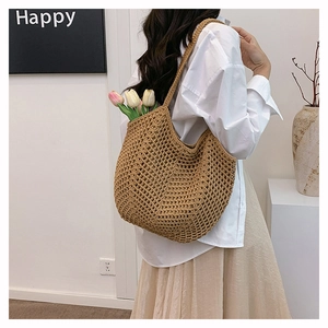 Close-up of khaki woven tote bag showing hollow crochet texture and large capacity