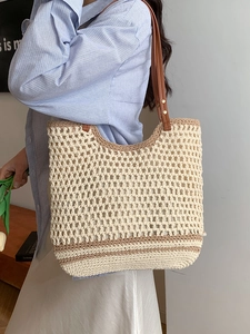 Handmade crochet woven tote bag with brown leather straps and striped bohemian pattern