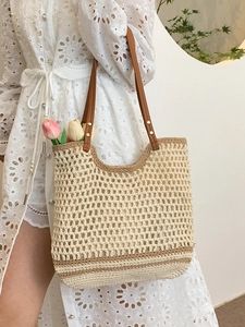 Artistic woven tote bag in cream and brown with leather handles for beach or commute