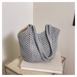 Close-up of light gray hollow-out crochet tote bag with durable lining and woven straps