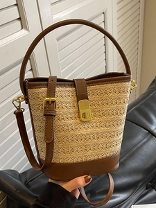 Chic straw bucket bag with brown leather trim and golden twist lock for women