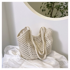 Close-up detail of the woven hollow mesh texture and soft inner lining on this beige tote