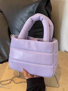 Quilted lavender bucket bag with plush padding and elegant silver ball chain strap