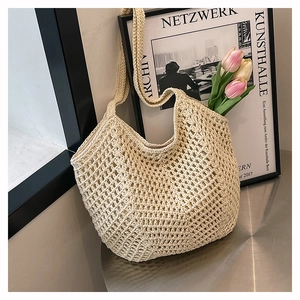 Detail of hollow woven tote bag in beige cotton with colorful tulips inside