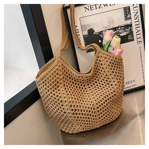 Detailed close-up of handmade woven mesh straw tote bag with crochet hollow design