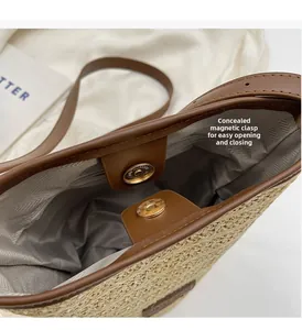Top view of woven straw bucket bag showing magnetic closure and herringbone fabric lining