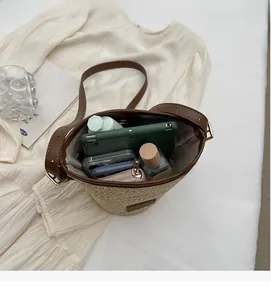 Top view of woven straw bucket bag showing spacious interior with leather trim