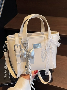 Minimalist beige wax leather bucket bag with silver heart charm and lace ribbon