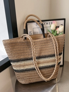 Large woven straw tote bag with brown and beige stripes for beach travel and vacations