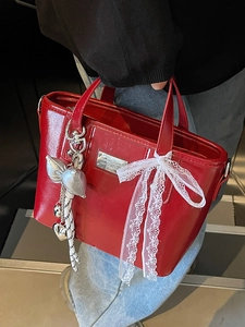 Chic red oil wax leather bucket bag with silver metal plaque and lace bow accessories