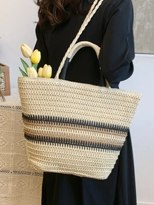 Chic hand-woven straw tote bag with black and beige stripes for summer beach travel use