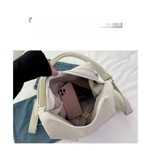 Top view showing large capacity and internal storage space of the white leather tote bag