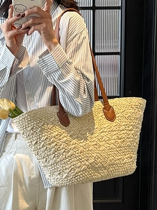 Handwoven straw tote bag with brown leather handles for summer beach vacations and daily use
