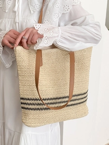 Straw tote bag with black stripes and brown leather straps for summer vacation