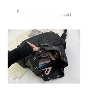 Detail view of large capacity black nylon backpack interior with tablets and cosmetics