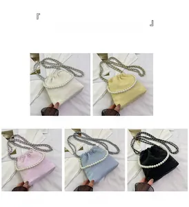 Detail der eleganten gerafften Handtasche mit Perlengriff und Metallkette in fünf Farben