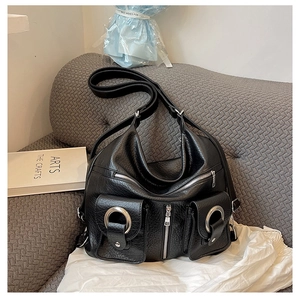 Detail of black pebbled faux leather tote with silver ring hardware and multi-pocket design