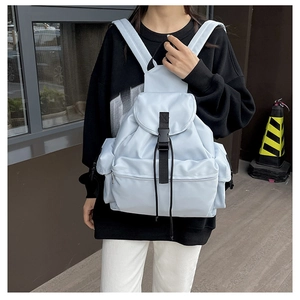 Detail view of water-resistant nylon backpack with black straps and buckle closure