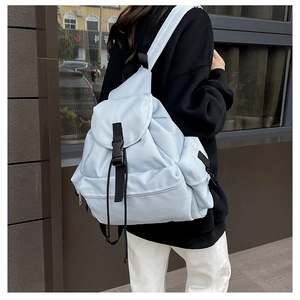 Outdoor shot of light blue large capacity backpack with flap and multi-pocket design