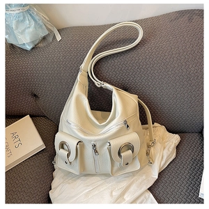 Detail of off-white lychee texture tote bag featuring silver ring magnetic pockets