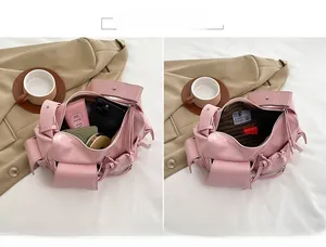 Pink faux leather shoulder bag interior detail showing spacious multi-pocket storage