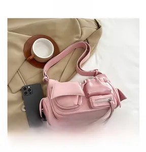 Detail view of pink functional shoulder bag with multi-pockets and glossy finish