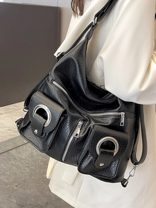 Minimalist black pebble leather tote bag with functional silver zippers and pockets