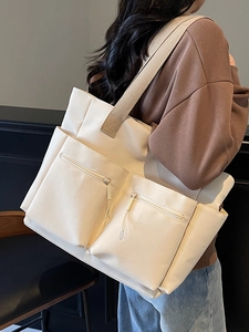 Minimalist off-white large capacity canvas tote bag featuring double front zip pockets