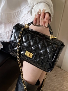 Elegant black patent leather crossbody bag with quilted pattern and gold metal clasp