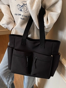 Black large capacity canvas tote bag with multiple pockets for daily travel use