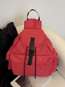 Classic red nylon backpack with large flap and buckle closure for casual travel