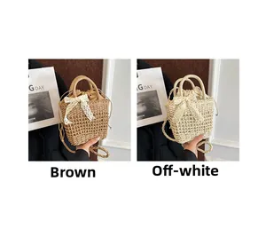 Detail view of woven straw handbags with lace bows and drawstring lining in brown and off-white