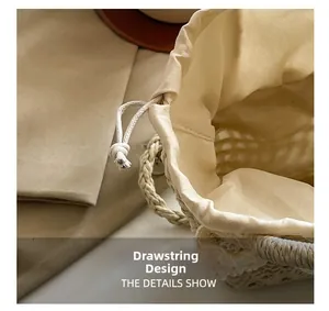 Close-up of woven straw bag showing the interior cream cotton lining and drawstring closure