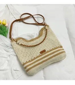 Detail of hand-woven beige bag featuring brown stripes and wooden beads on the strap