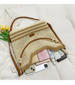 Detail view of woven contrast tote bag with leather strap and wooden bead accents