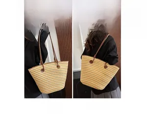 Détail montrant les modes porté main et épaule du grand sac cabas tissé à rayures