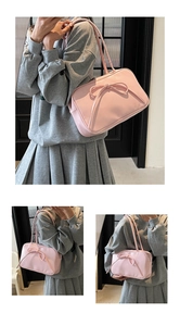 Detail of pink bow shoulder bag with large ribbon decor on a minimalist Boston bag
